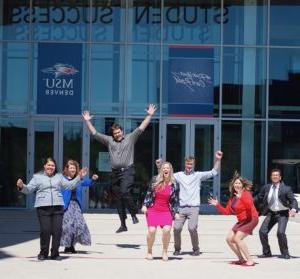 CESA team jumping in front of the Jordan Student Success building